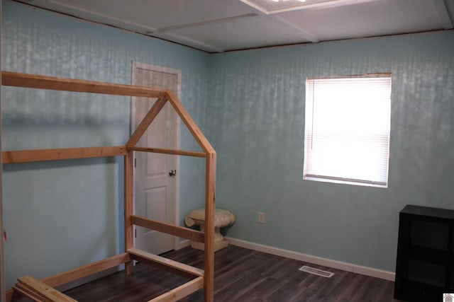 bedroom with dark hardwood / wood-style floors