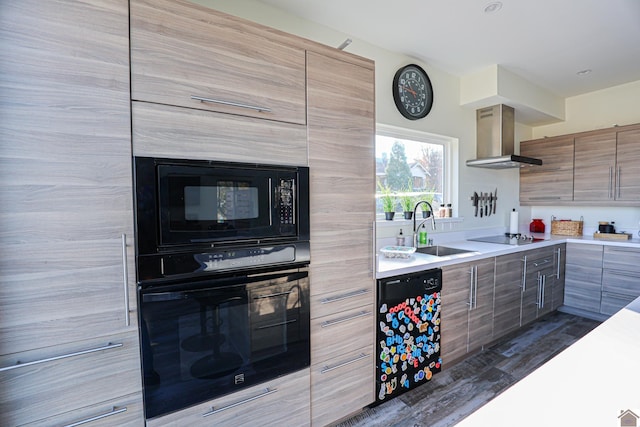 kitchen with black appliances, wall chimney exhaust hood, dark hardwood / wood-style floors, and sink