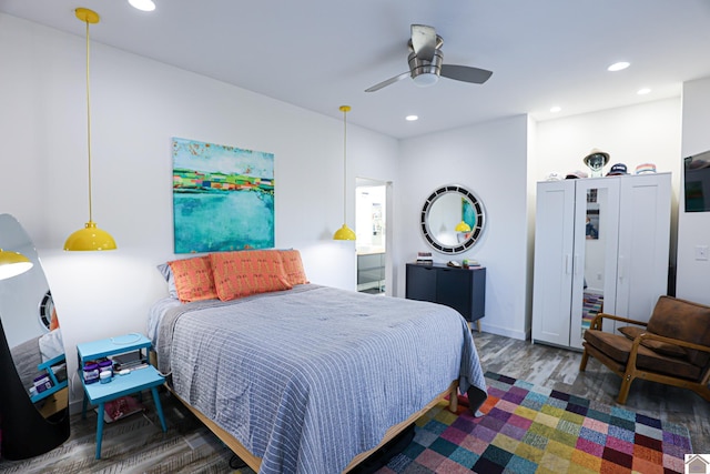 bedroom with dark hardwood / wood-style floors and ceiling fan