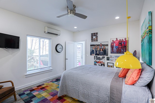 bedroom featuring ceiling fan and a wall mounted AC