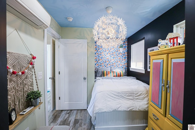 bedroom featuring dark hardwood / wood-style flooring and a wall mounted AC