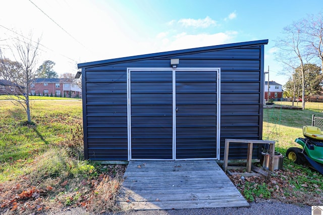 view of outbuilding with a lawn