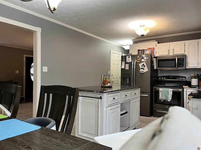 210 Banberry Bnd, Paducah, KY 42001 - kitchen featuring white cabinets, crown molding, light colored carpet, and stainless steel appliances