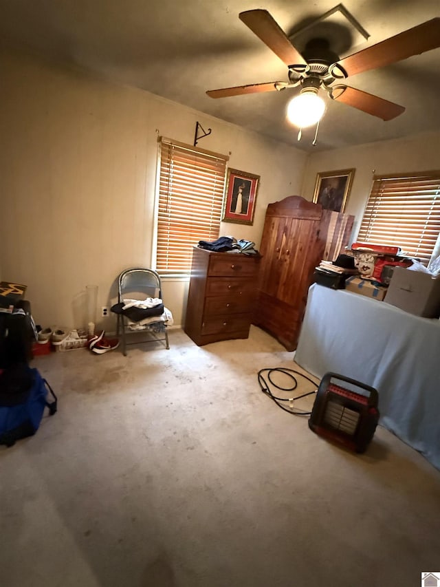 bedroom with ceiling fan and light carpet