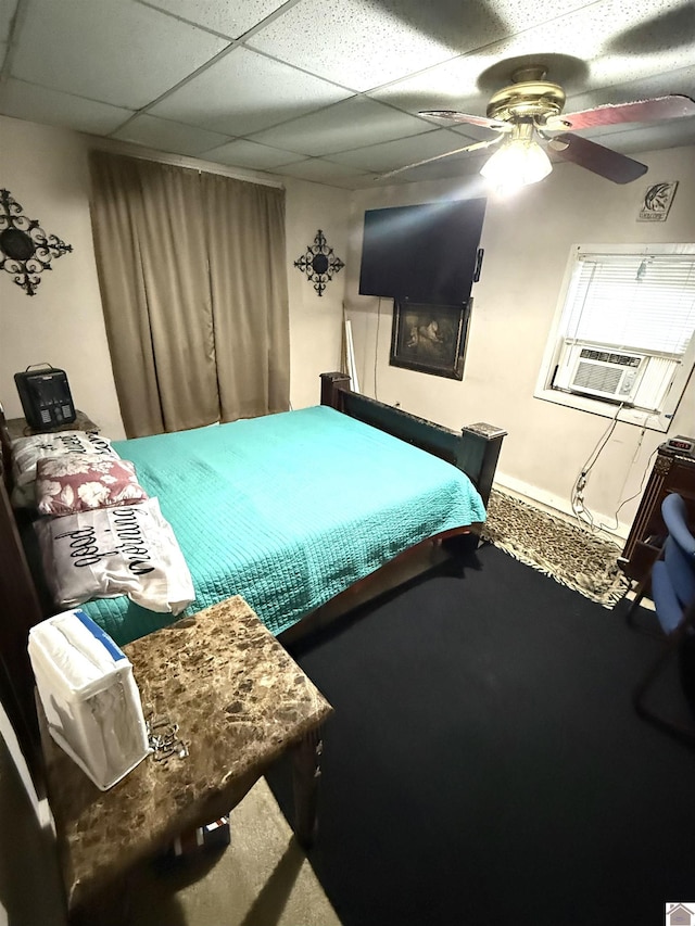 bedroom with a paneled ceiling, carpet floors, ceiling fan, and cooling unit