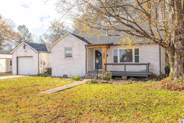 view of front of property with a front yard and a garage