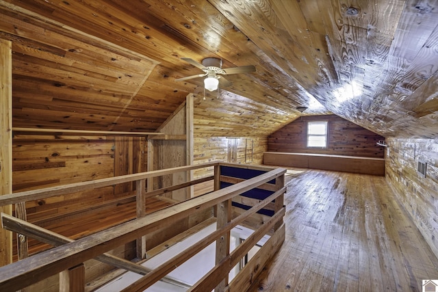 bonus room featuring wooden walls, wooden ceiling, lofted ceiling, and hardwood / wood-style flooring