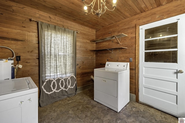 laundry room with washing machine and clothes dryer, wooden walls, wood ceiling, and a notable chandelier