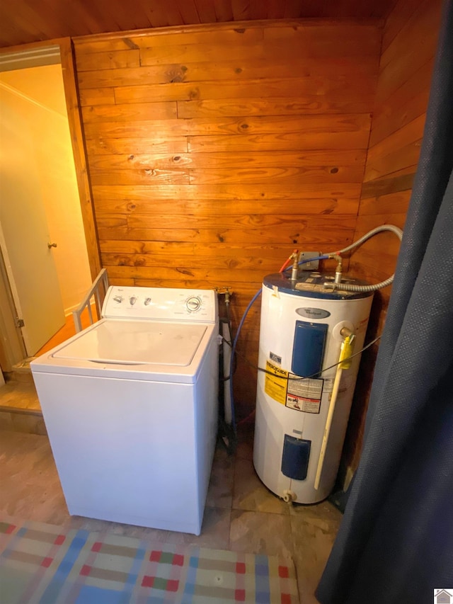 washroom with washer / clothes dryer, wooden walls, and electric water heater