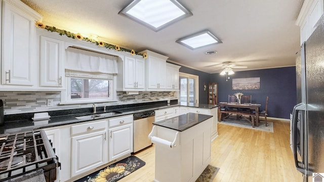 155 County Line Rd, Paducah, KY 42003 - kitchen featuring black appliances, white cabinets, decorative backsplash, a peninsula, and light wood-type flooring