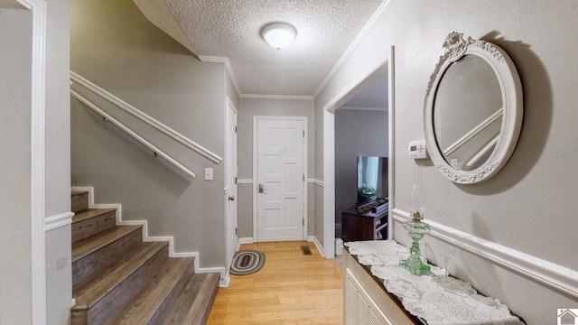 155 County Line Rd, Paducah, KY 42003 - foyer featuring light wood-style floors, a textured ceiling, stairway, and crown molding