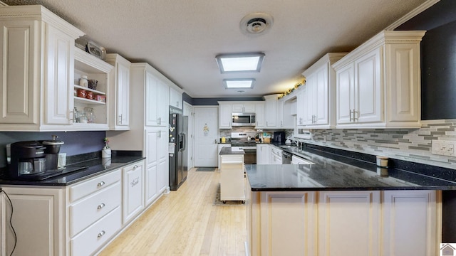 155 County Line Rd, Paducah, KY 42003 - kitchen featuring stainless steel appliances, light wood-type flooring, a peninsula, decorative backsplash, and open shelves