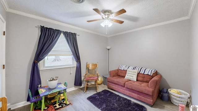 155 County Line Rd, Paducah, KY 42003 - living room with wood finished floors, a ceiling fan, a textured ceiling, and ornamental molding