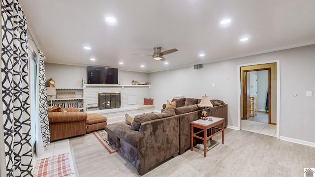 155 County Line Rd, Paducah, KY 42003 - living room featuring a ceiling fan, ornamental molding, light wood-style flooring, recessed lighting, and a brick fireplace