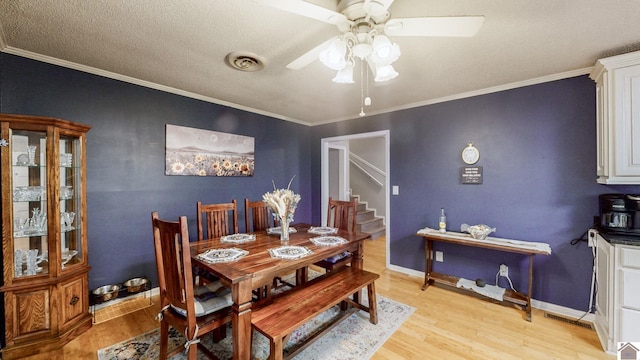 155 County Line Rd, Paducah, KY 42003 - dining room featuring ceiling fan, light wood-type flooring, stairs, crown molding, and a textured ceiling
