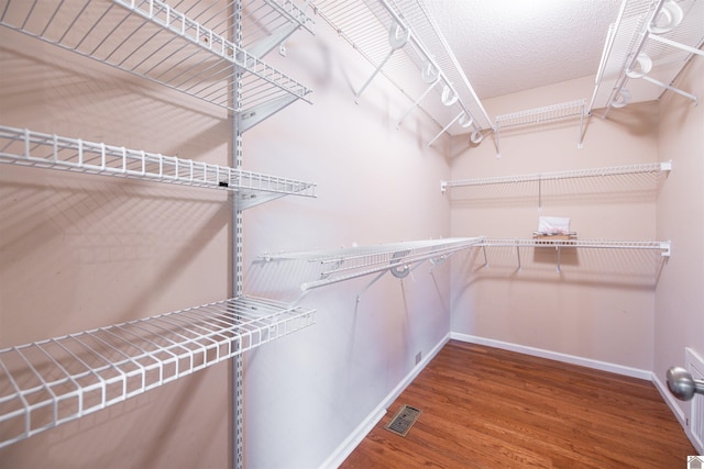 spacious closet with hardwood / wood-style floors