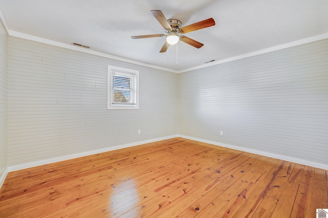 spare room featuring ceiling fan, crown molding, and light hardwood / wood-style flooring