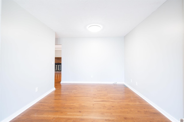 spare room with light hardwood / wood-style flooring