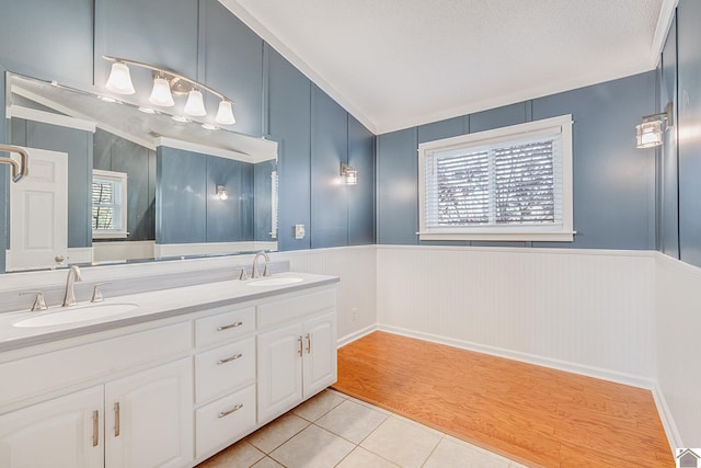 bathroom featuring hardwood / wood-style floors, vanity, and a textured ceiling