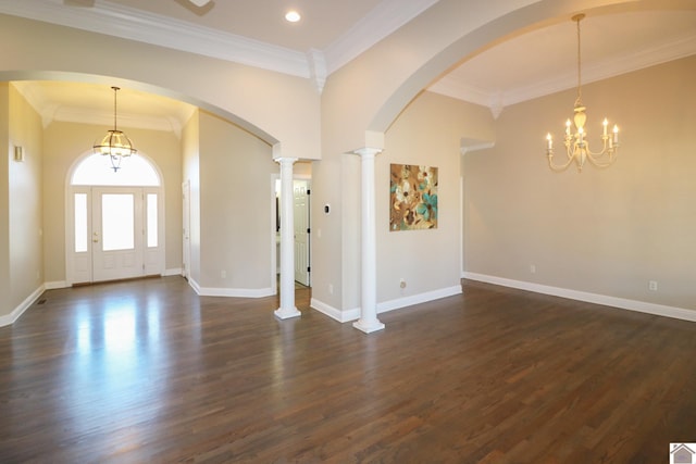 entrance foyer with a chandelier, dark hardwood / wood-style flooring, decorative columns, and crown molding