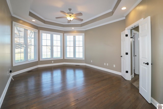 spare room featuring plenty of natural light, ornamental molding, and dark wood-type flooring