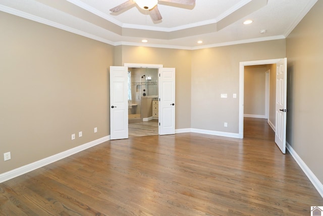 unfurnished bedroom featuring wood-type flooring, connected bathroom, ceiling fan, and ornamental molding