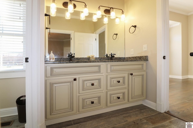 bathroom featuring crown molding, vanity, and wood-type flooring