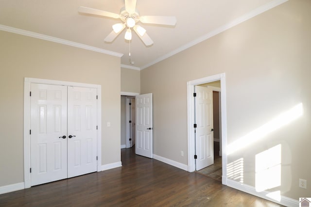 unfurnished bedroom featuring a closet, ceiling fan, dark hardwood / wood-style flooring, and ornamental molding