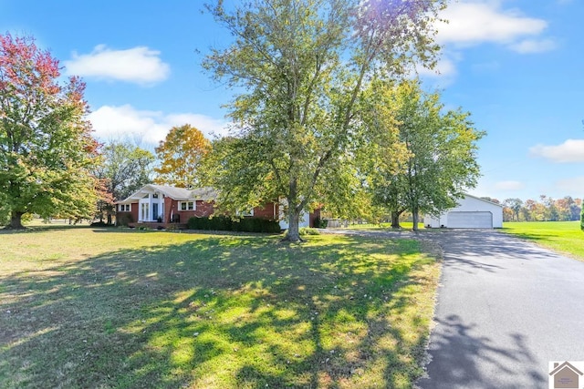 view of front of home featuring a garage and a front lawn