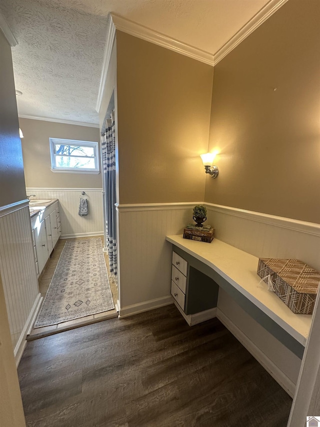 bathroom featuring sink, ornamental molding, a textured ceiling, and hardwood / wood-style flooring