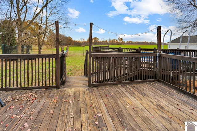 wooden deck with a lawn and a trampoline