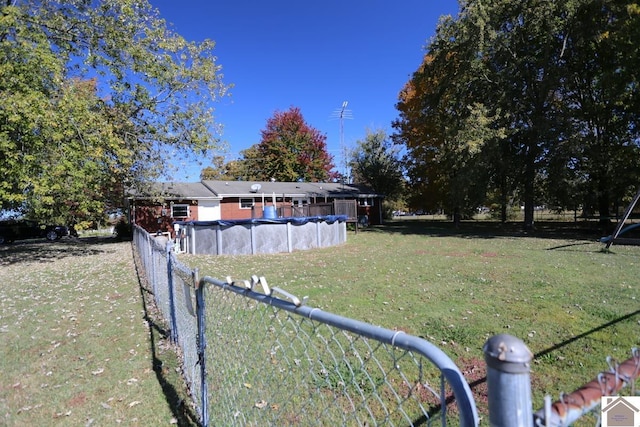 view of yard with a covered pool