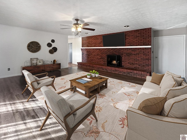 living room with hardwood / wood-style floors, a textured ceiling, and ceiling fan