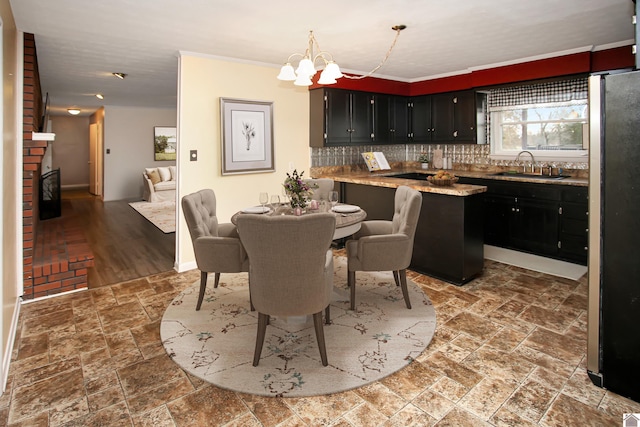 dining space featuring a chandelier, hardwood / wood-style flooring, and sink