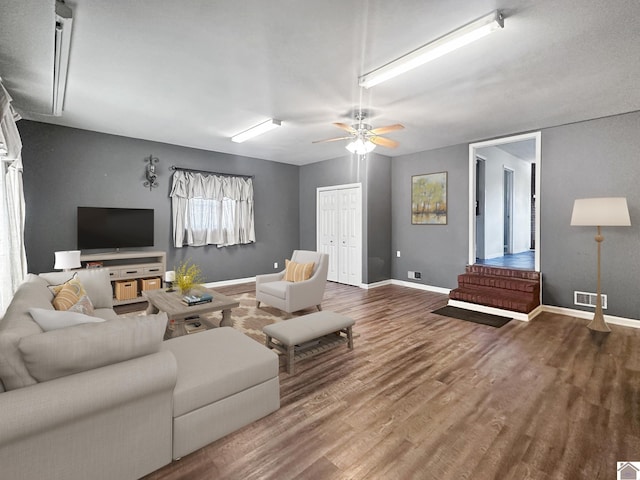 living room featuring ceiling fan and wood-type flooring