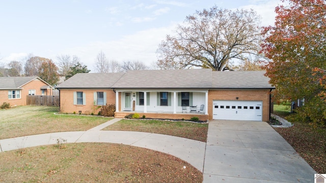 ranch-style house featuring a front lawn, covered porch, and a garage