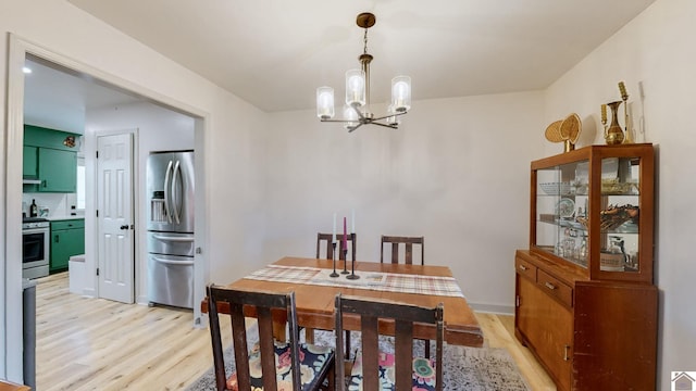 dining room with a notable chandelier and light hardwood / wood-style floors