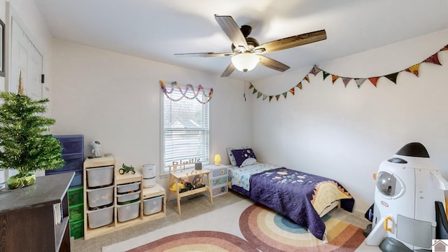 carpeted bedroom featuring ceiling fan