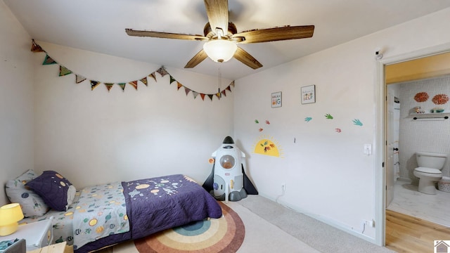 bedroom featuring ceiling fan, ensuite bathroom, and light hardwood / wood-style floors