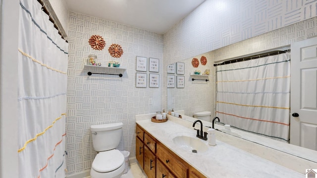 bathroom with walk in shower, vanity, and toilet