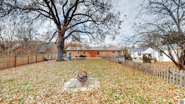 view of yard with an outdoor fire pit