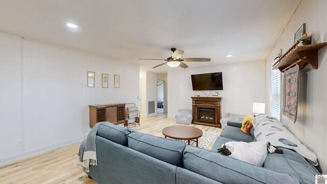 living room with ceiling fan and light wood-type flooring