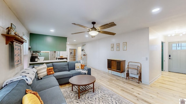 living room featuring ceiling fan and light wood-type flooring