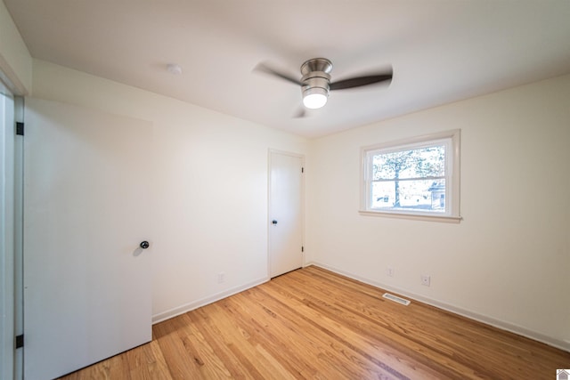 empty room featuring light wood-type flooring and ceiling fan