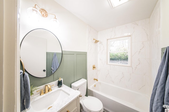 full bathroom with toilet, vanity, and tiled shower / bath