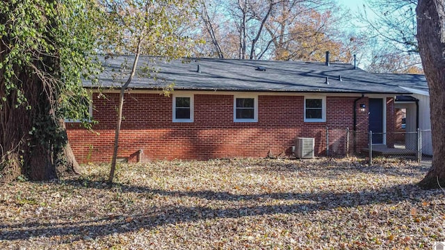 view of side of home with central AC unit