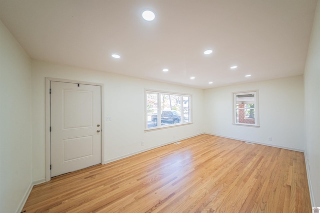 empty room with light hardwood / wood-style flooring