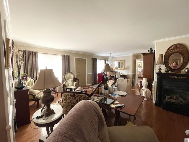 living room featuring wood-type flooring, a healthy amount of sunlight, and ornamental molding