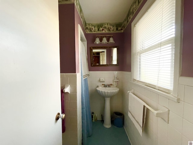 bathroom featuring tile walls and sink