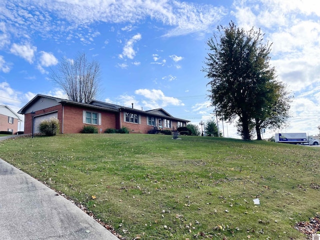 view of front of home with a garage and a front lawn